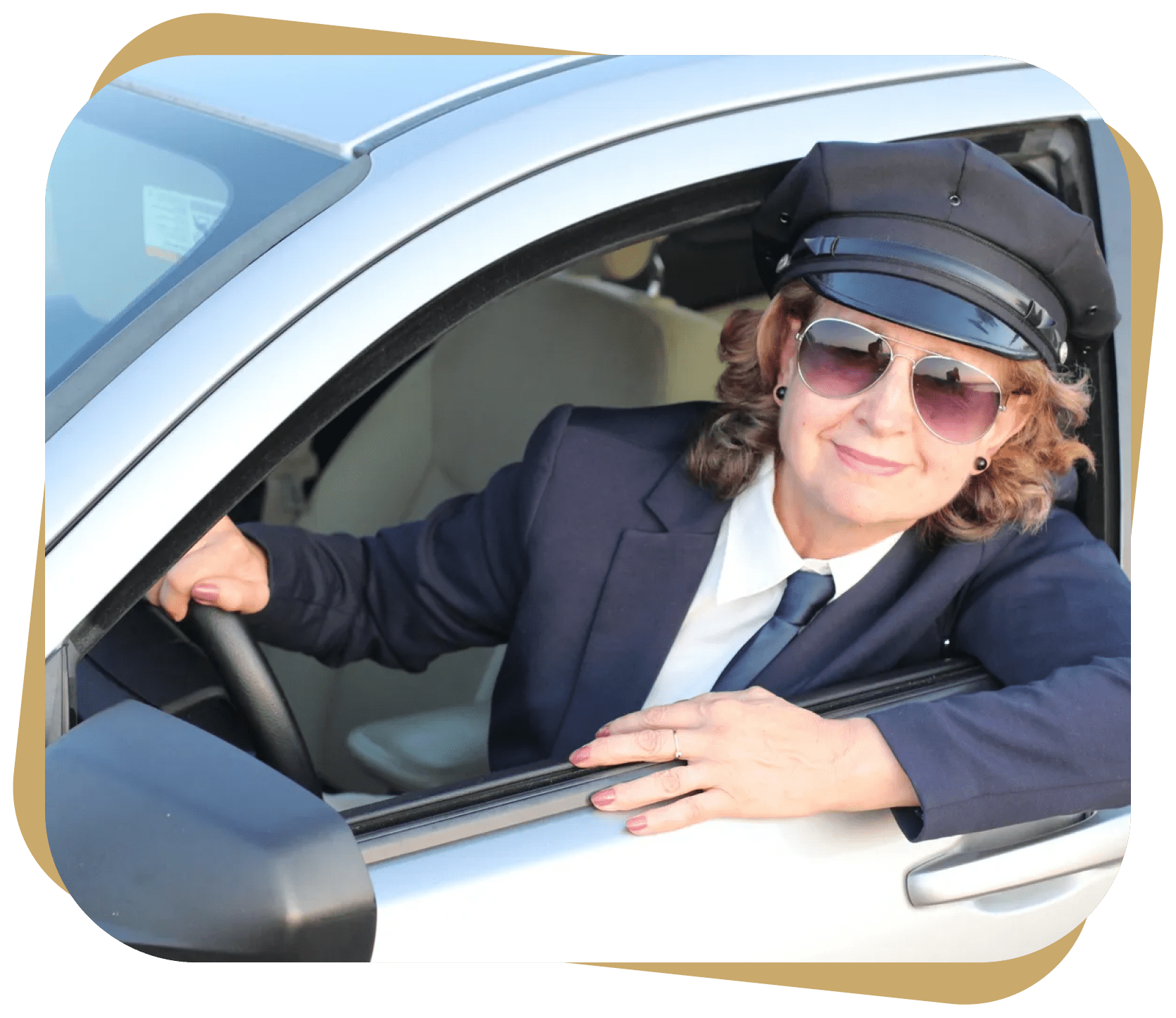 Smiling female chauffeur in her car.