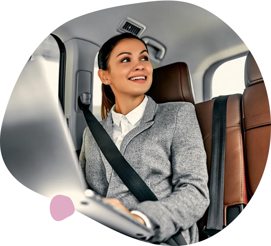 Businesswoman working on laptop in car.